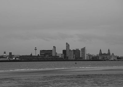 View of buildings by sea