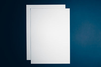 Close-up of white paper against blue background