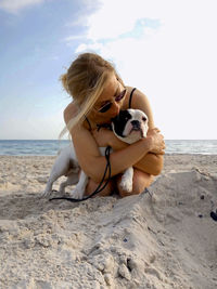 Girl with a dog on the beach. warm colors of the sky