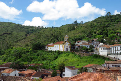 Houses in town against sky