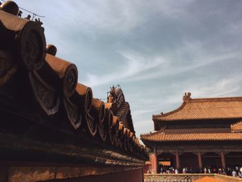 Low angle view of temple against cloudy sky