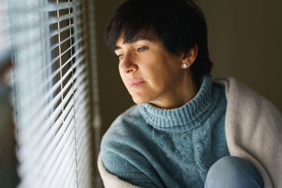 Portrait of woman sitting at home