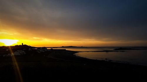 Scenic view of sea against orange sky
