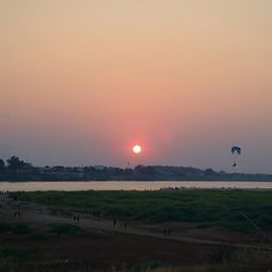 Scenic view of field against sky during sunset