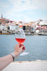 Man holding ice cream against buildings in city