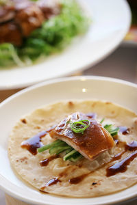 High angle view of fish on flat bread in plate