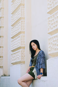 Portrait of young happy brunette asian woman relaxing in city, park. lake. summer vacation. travel