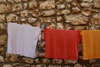 Close-up of clothes drying against wall