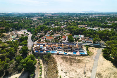 High angle view of buildings and trees against sky