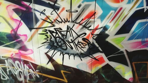 Close-up of colorful graffiti on wall
