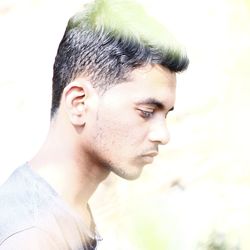 Close-up portrait of young man looking away