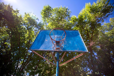 Low angle view of basketball hoop against trees