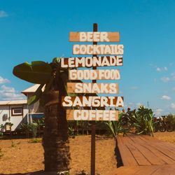 Information sign against blue sky