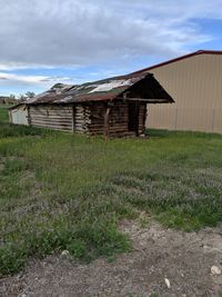 Barn on field against sky