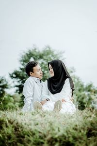 Couple kissing on field