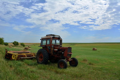 Tractor on field against sky