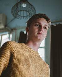 Portrait of young man looking at home