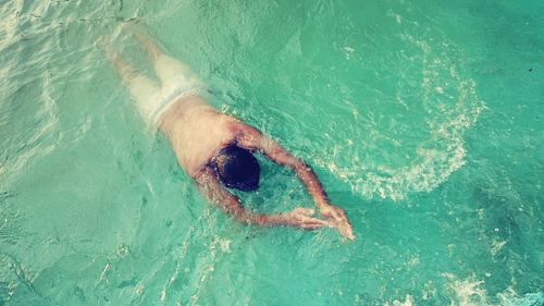 High angle view of man swimming in sea