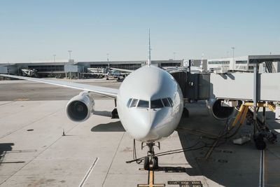 Airplane at airport against sky