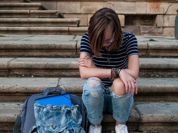 Full length of teenage girl sitting on steps