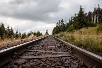 Surface level of railroad tracks against sky