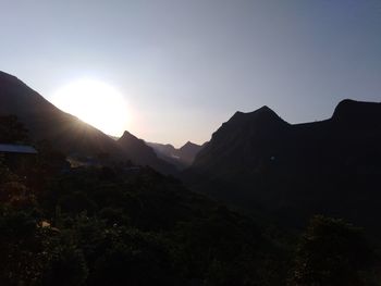 Scenic view of silhouette mountains against sky at sunset