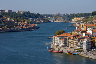 Scenic view of sea and buildings against clear sky