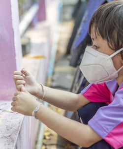 Close-up of girl wearing surgical mask