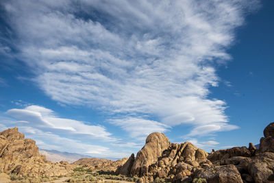 Low angle view of rocks against blue sky