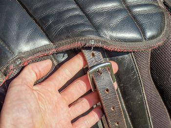 High angle view of person hand holding leather