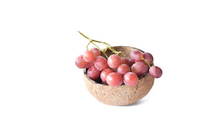 Close-up of cherries in bowl against white background