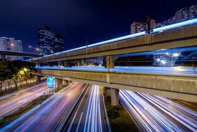 High angle view of light trails on bridge at night