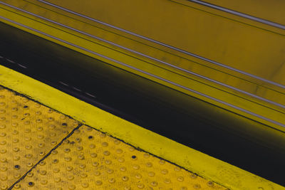 Close-up of yellow train on railroad station platform