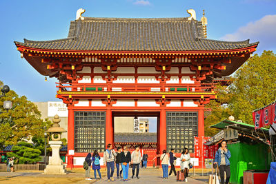 Group of people in temple outside building