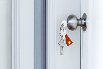 Close-up of key hanging from doorknob