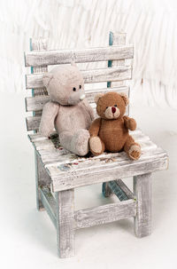 Stuffed toys on wooden chair