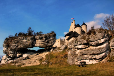 Horse on rock against sky