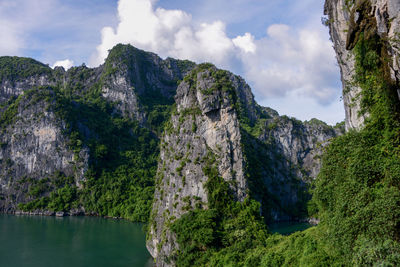 Scenic view of mountains and trees against sky