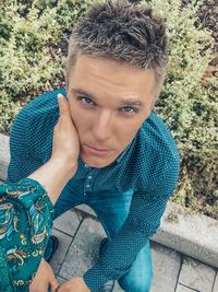 Portrait of teenage boy sitting outdoors