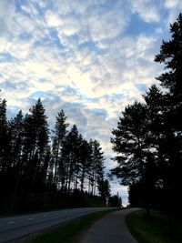 Empty road against cloudy sky