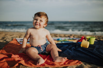 Boy sitting on beach