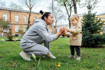 Grandparents in kids life, grandparents teach children. senior woman grandmother and little toddler