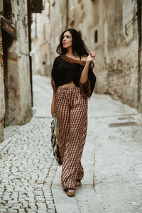 Portrait of young woman standing outdoors