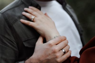 Midsection of couple holding hands