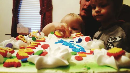 Cute girl with multi colored hands at home