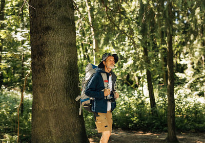 Rear view of man standing in forest