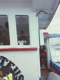 People in boat against sea