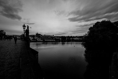 Scenic view of river against sky in city