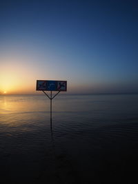 Scenic view of sea against clear sky during sunset