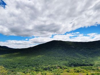 Scenic view of landscape against cloudy sky